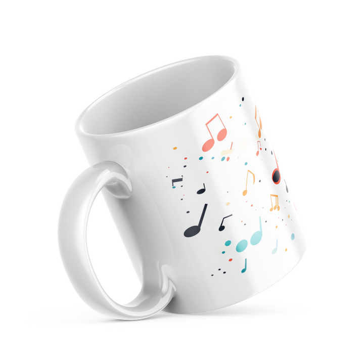 Two ceramic coffee mugs with a colorful musical notes and confetti design, one with the handle up and the other with the handle down, on a white background.