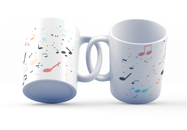 Two ceramic coffee mugs with a colorful musical notes and confetti design, one with the handle up and the other with the handle down, on a white background.