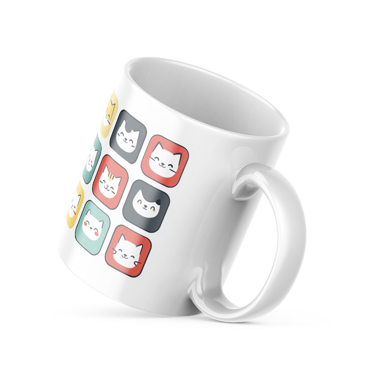 A ceramic coffee mug with a colorful cat face pattern on one side and a 'Good Morning' message with paw prints on the other, placed inside and outside of the mug.