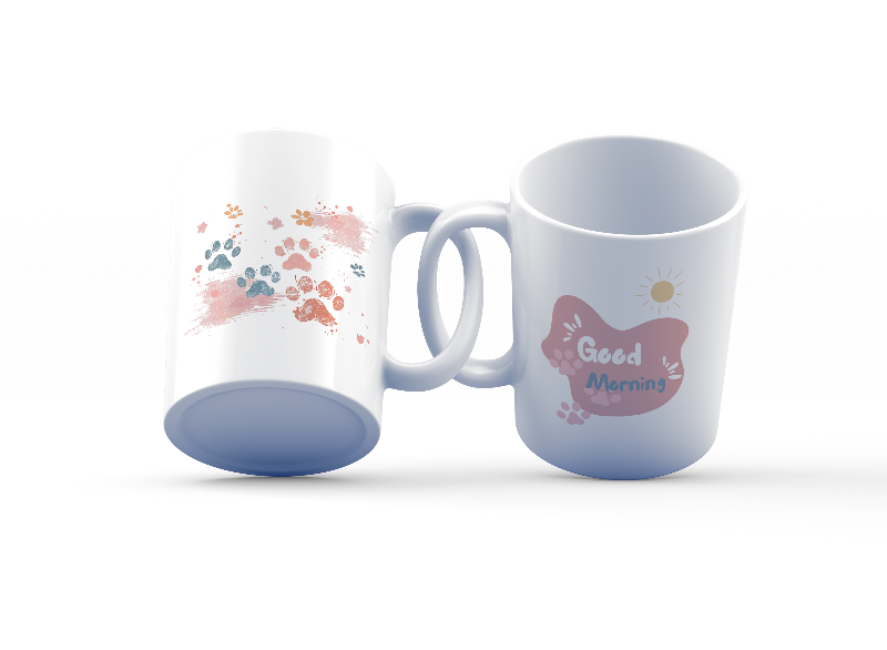 A set of two ceramic mugs, one with a splash of colorful paw prints and the other with a 'Good Morning' message in soft pink, both with animal-themed designs.