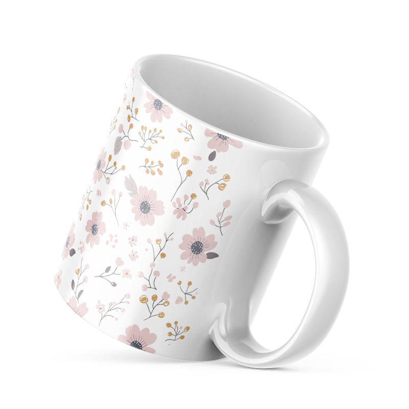Two ceramic coffee mugs with a floral pattern, one with the handle up and the other with the handle down, on a white background.