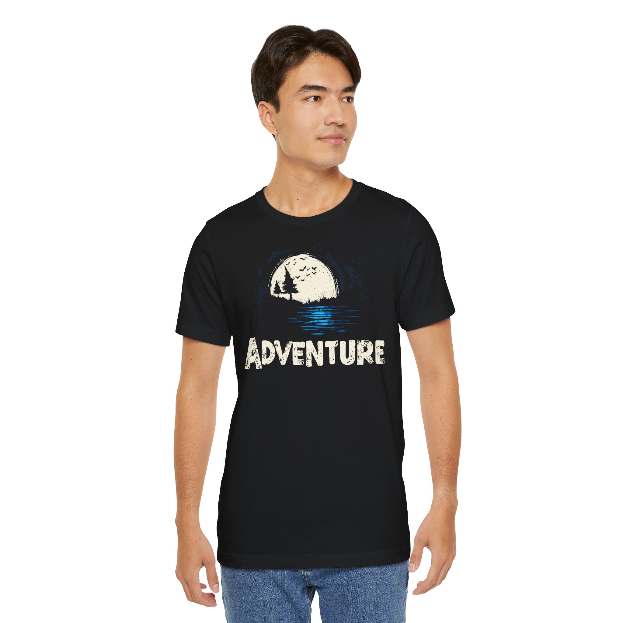 Man wearing a black t-shirt with 'Adventure' graphic design on a white background