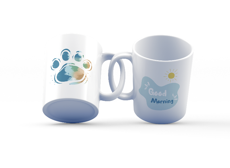 A set of two ceramic mugs, one with a 'Good Morning' message and a paw print design, and the other with a 'Paw Print Earth' design. Both mugs have a glossy white background with colorful prints.