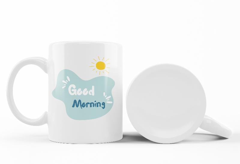 A set of two ceramic mugs, one with a 'Good Morning' message and a paw print design, and the other with a 'Paw Print Earth' design. Both mugs have a glossy white background with colorful prints.