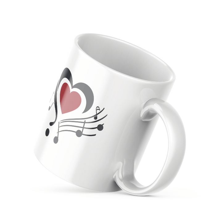 Two ceramic mugs, one with a heart and flowing music notes design in red, black, and gold, and the other with a 'Good Morning' message in the same color palette.