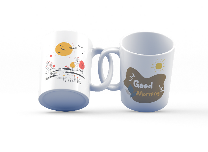 Two ceramic mugs side by side, one with a 'Good Morning' design and the other featuring a scenic nature landscape with trees and a sun rise.