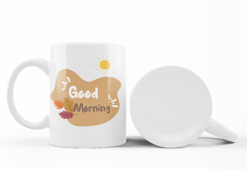 A set of two ceramic mugs, one with a floral design of golden roses and autumn leaves, and the other with a sun and leaves pattern, both with 'Good Morning' and 'Good Afternoon' text respectively.