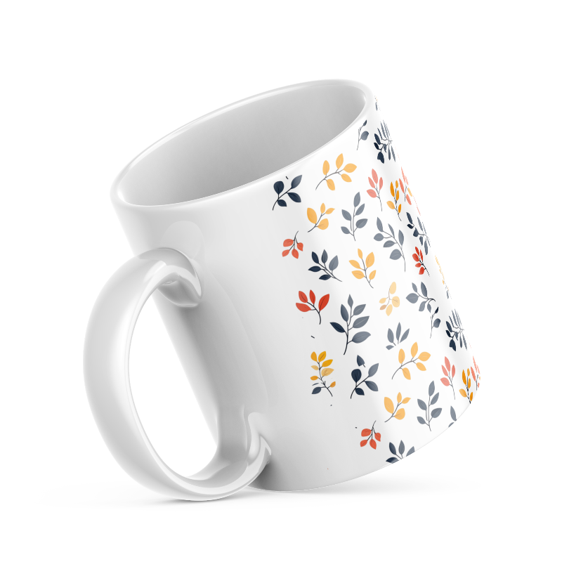 A set of two ceramic coffee mugs with a floral and autumn leaf design on a white background, one mug is filled with a liquid, possibly coffee or tea.