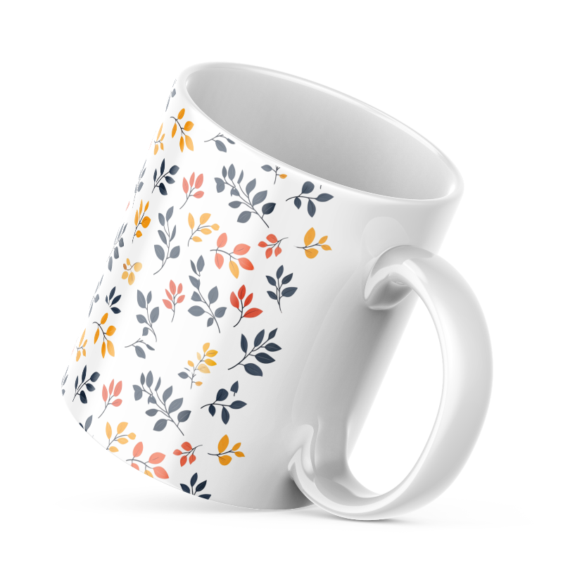 A set of two ceramic coffee mugs with a floral and autumn leaf design on a white background, one mug is filled with a liquid, possibly coffee or tea.
