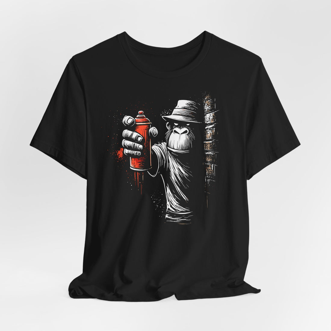 Black t-shirt with a graphic design of a person holding a spray can and books on a white background