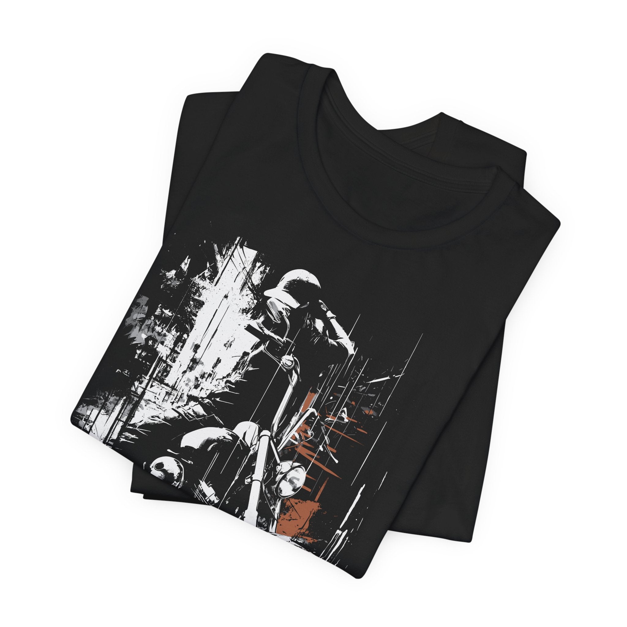 Black t-shirt with graphic design of a person on a motorcycle, folded on a white background