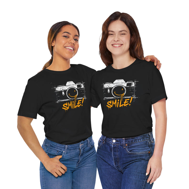 Two people wearing black t-shirts with a camera graphic and 'SMILE!' text on a white background.