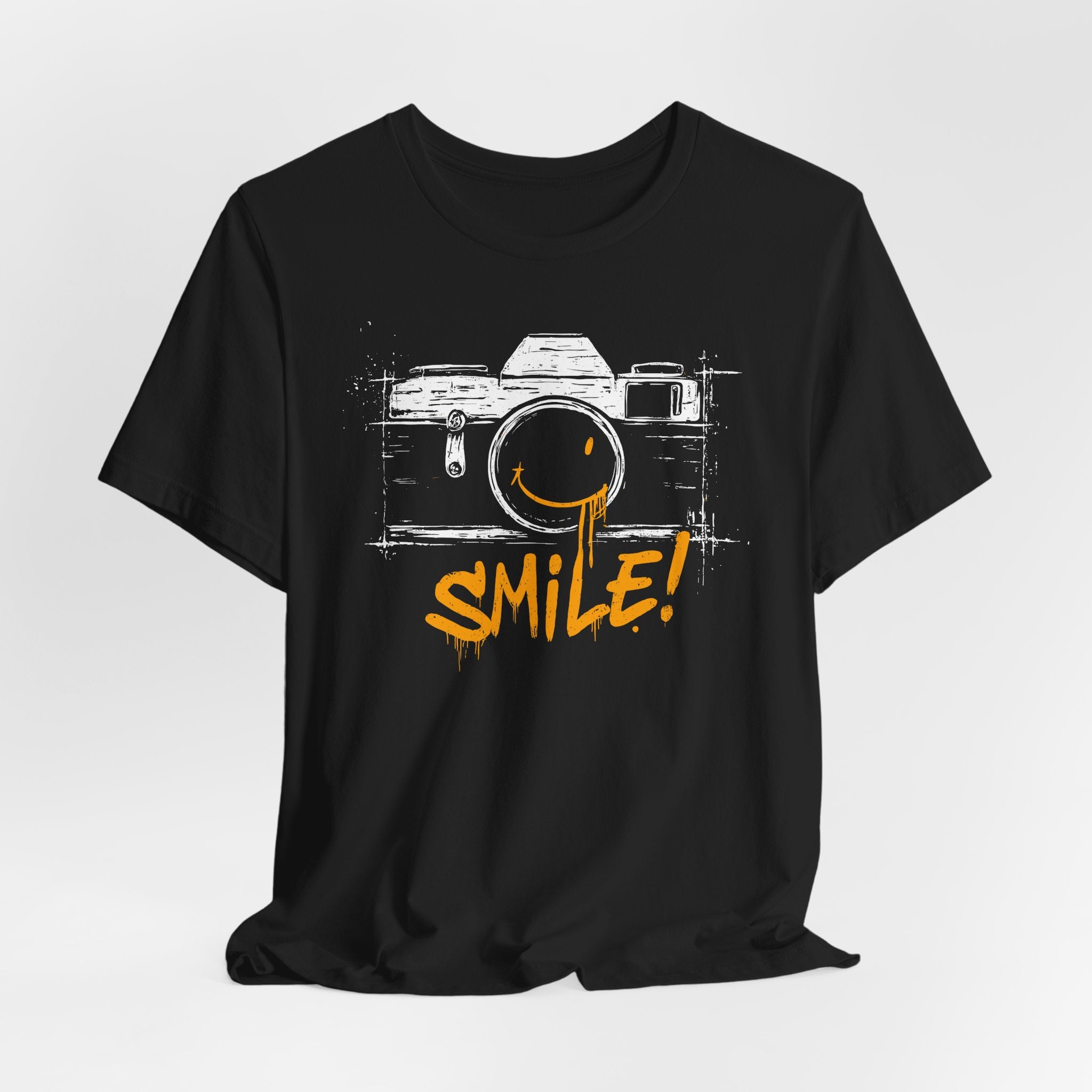 Black t-shirt with a camera graphic and 'SMILE!' text on a white background