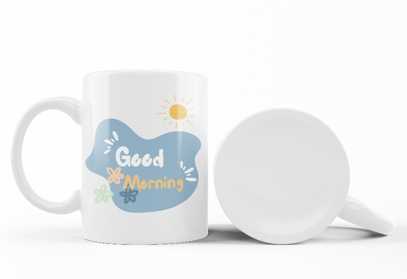 A set of two ceramic mugs, one with a 'Good Morning' message and floral design, and the other featuring a blue flower illustration.