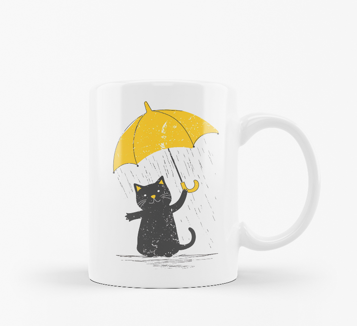 Two ceramic mugs, one with a 'Good Morning' text and paw prints, and the other featuring a black cat holding a yellow umbrella.