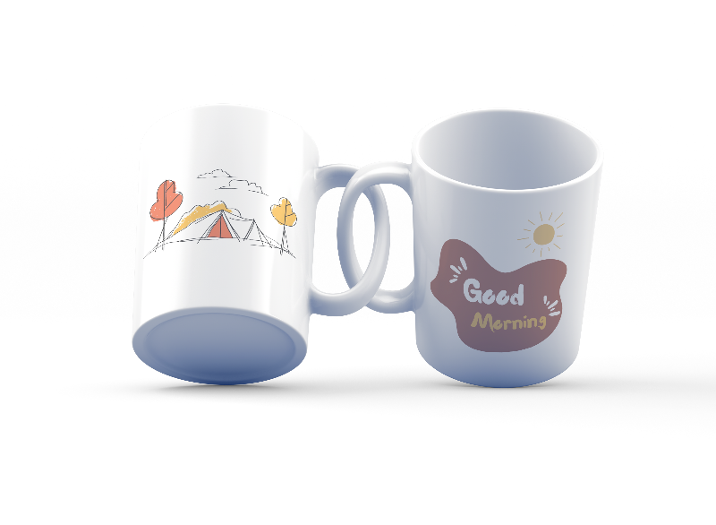 Two ceramic mugs, one with a camping tent and sun design and the other with a 'Good Morning' text and sun design, both in white with colorful illustrations.