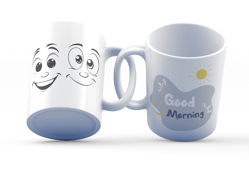Two ceramic coffee mugs, one with a smiling face design and 'Good Morning' text, the other with a sun and 'Good Afternoon' text. Both have a white background with decorative elements.