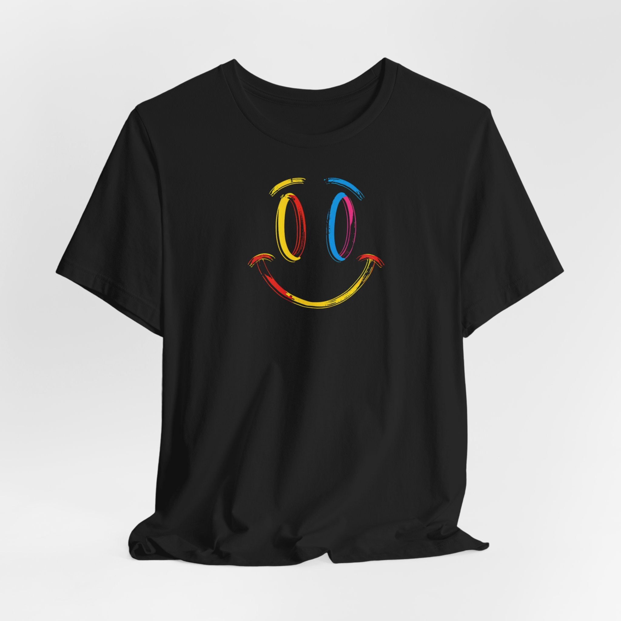 A black t-shirt with a vibrant colorful smiley face design on the front.