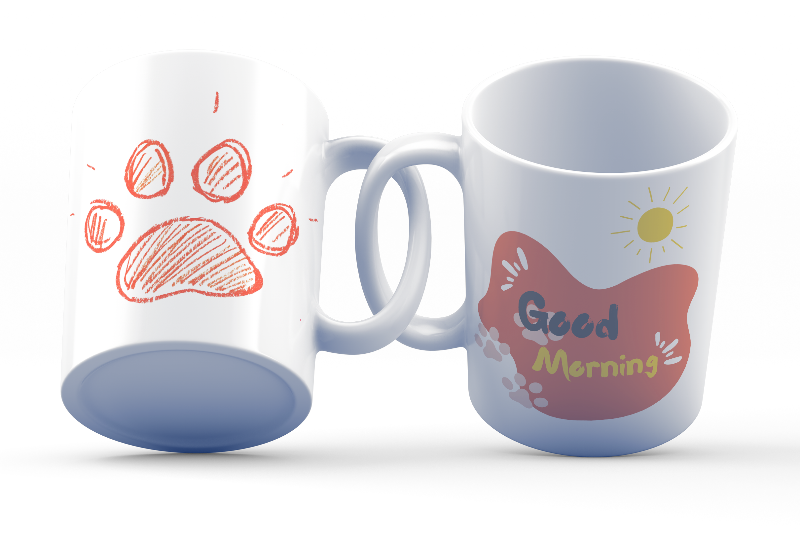 A double-sided ceramic coffee mug with an orange paw print design and 'Good Morning' message on one side, and a plain background on the other.