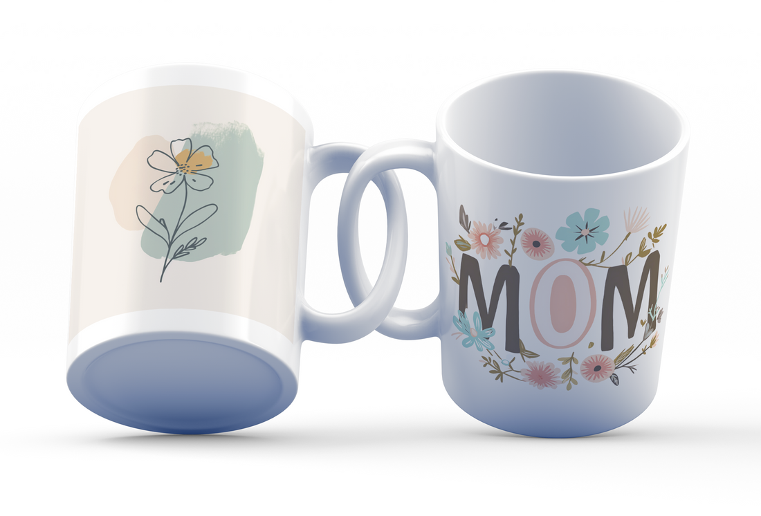 A ceramic mug with a floral design, featuring the word 'MOM' on one side and a single flower on the other, in pastel colors.