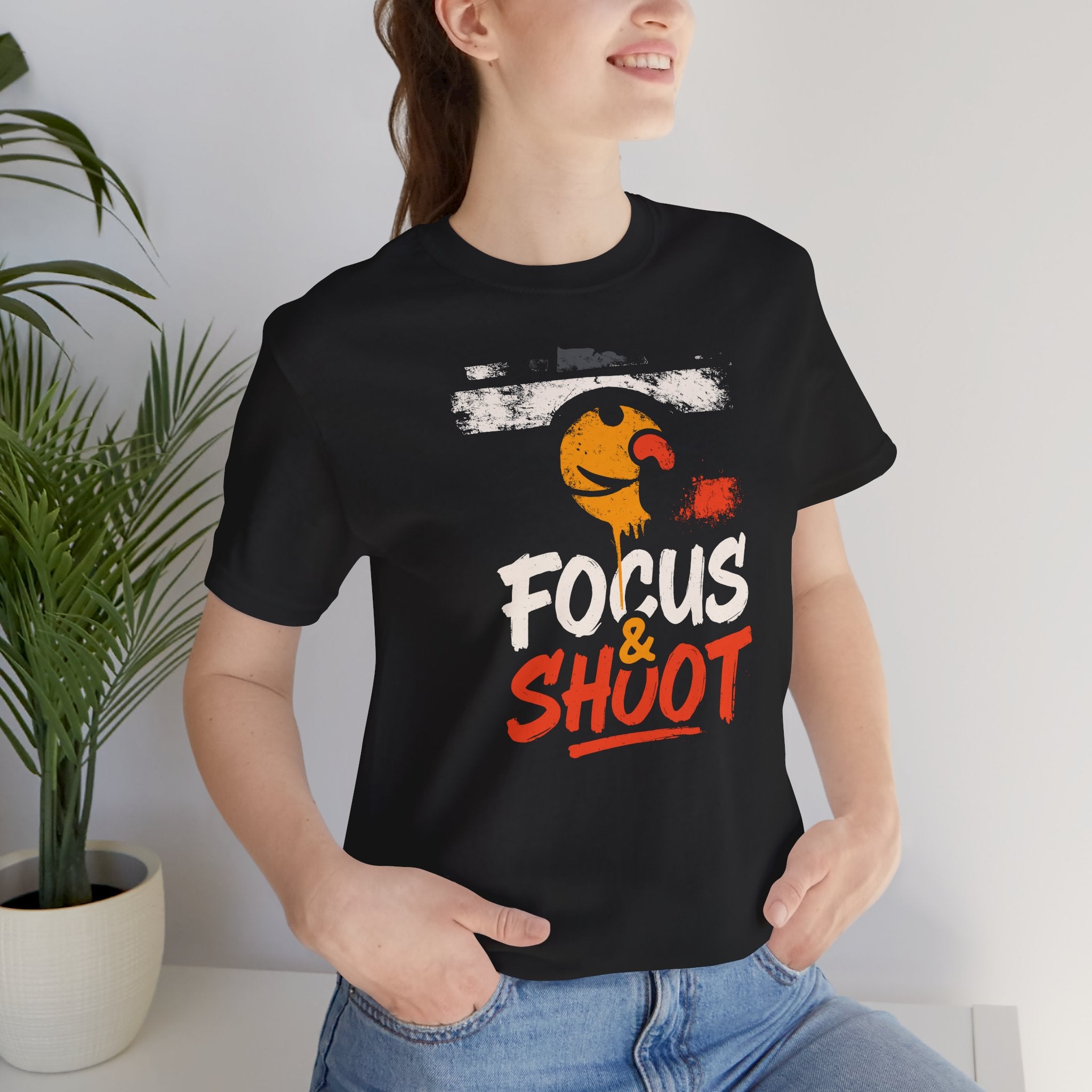Person wearing a black t-shirt with 'Focus & Shout' graphic design.
