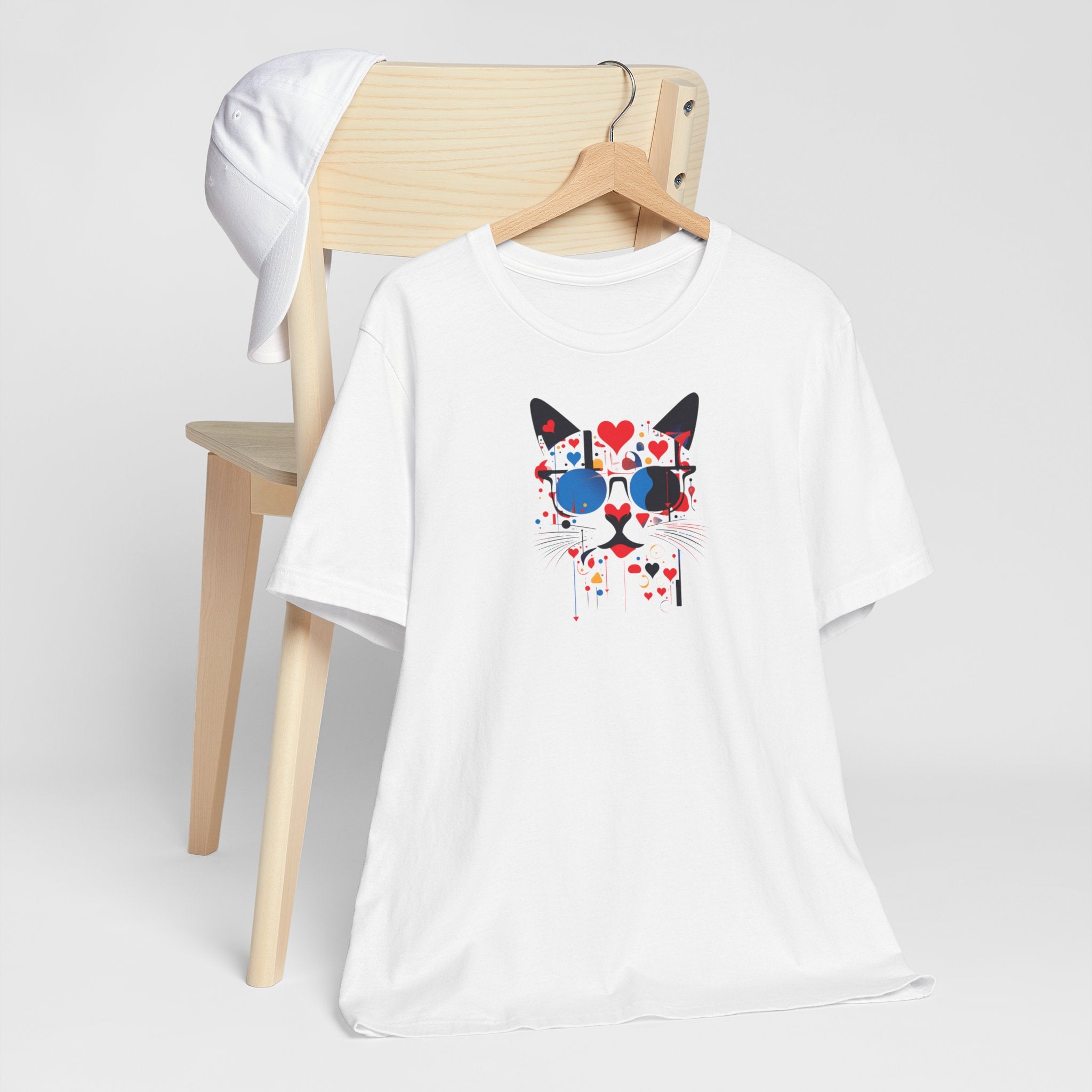 White t-shirt with black cat face, blue sunglasses and red hearts