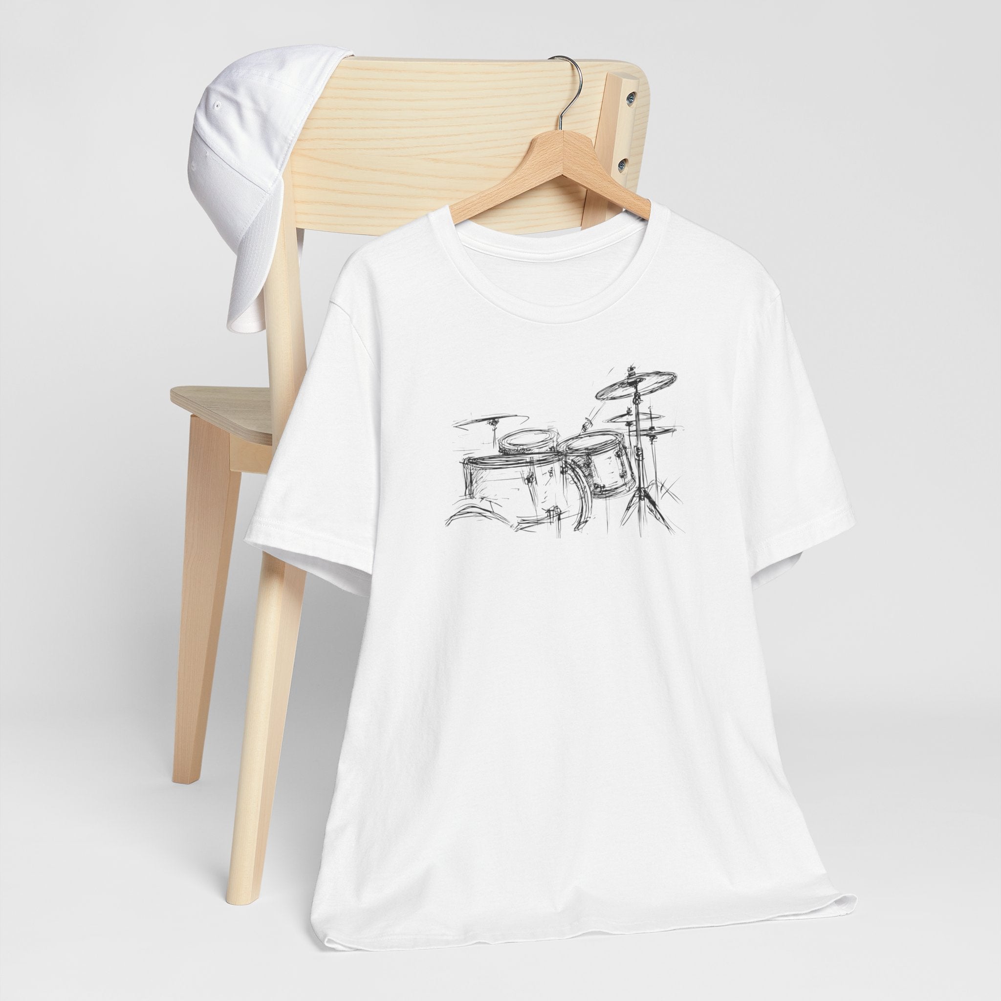 White cotton t-shirt with a hand-drawn artistic sketch of a drum kit in the center.