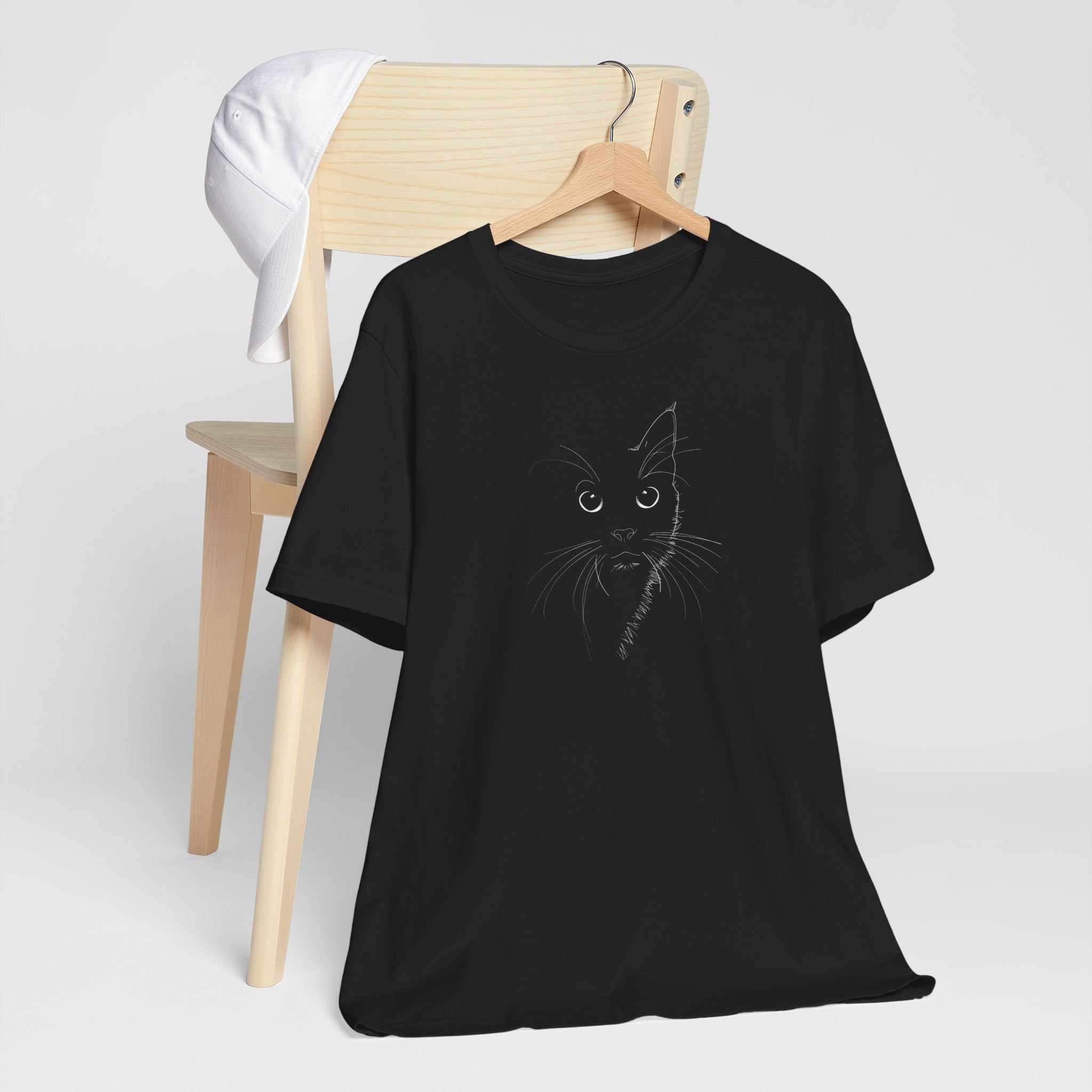 Black t-shirt with a minimalist line drawing of a cat's face on the front.