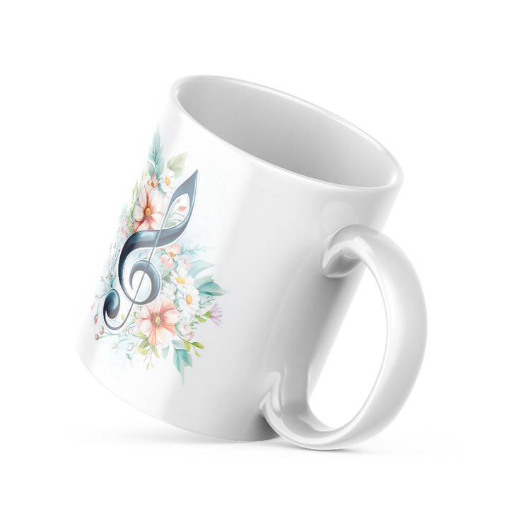 Two ceramic coffee mugs with floral and musical designs. One mug has a floral treble clef design with the text 'Good Morning' and musical notes, while the other has a simple 'Good' design with a sun motif.