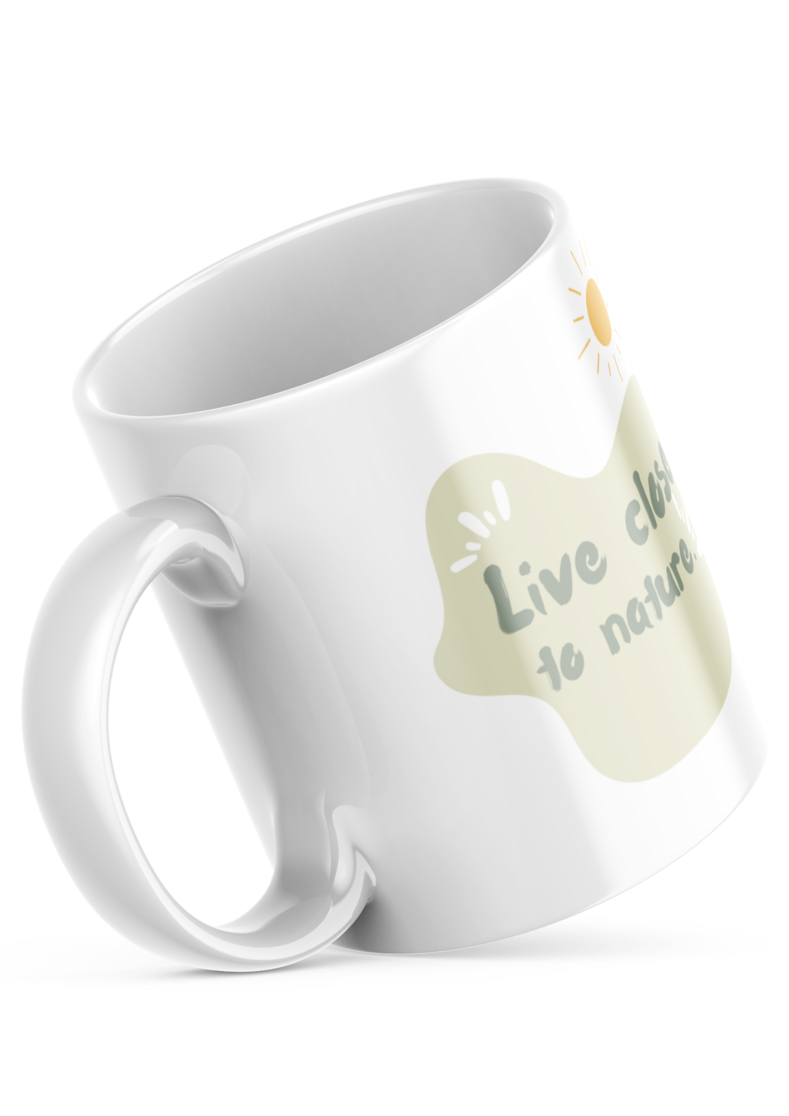 Two white ceramic mugs with a green and brown tree illustration and the quote 'Live Close to Nature'. One mug shows the exterior while the other displays the interior with a beverage.