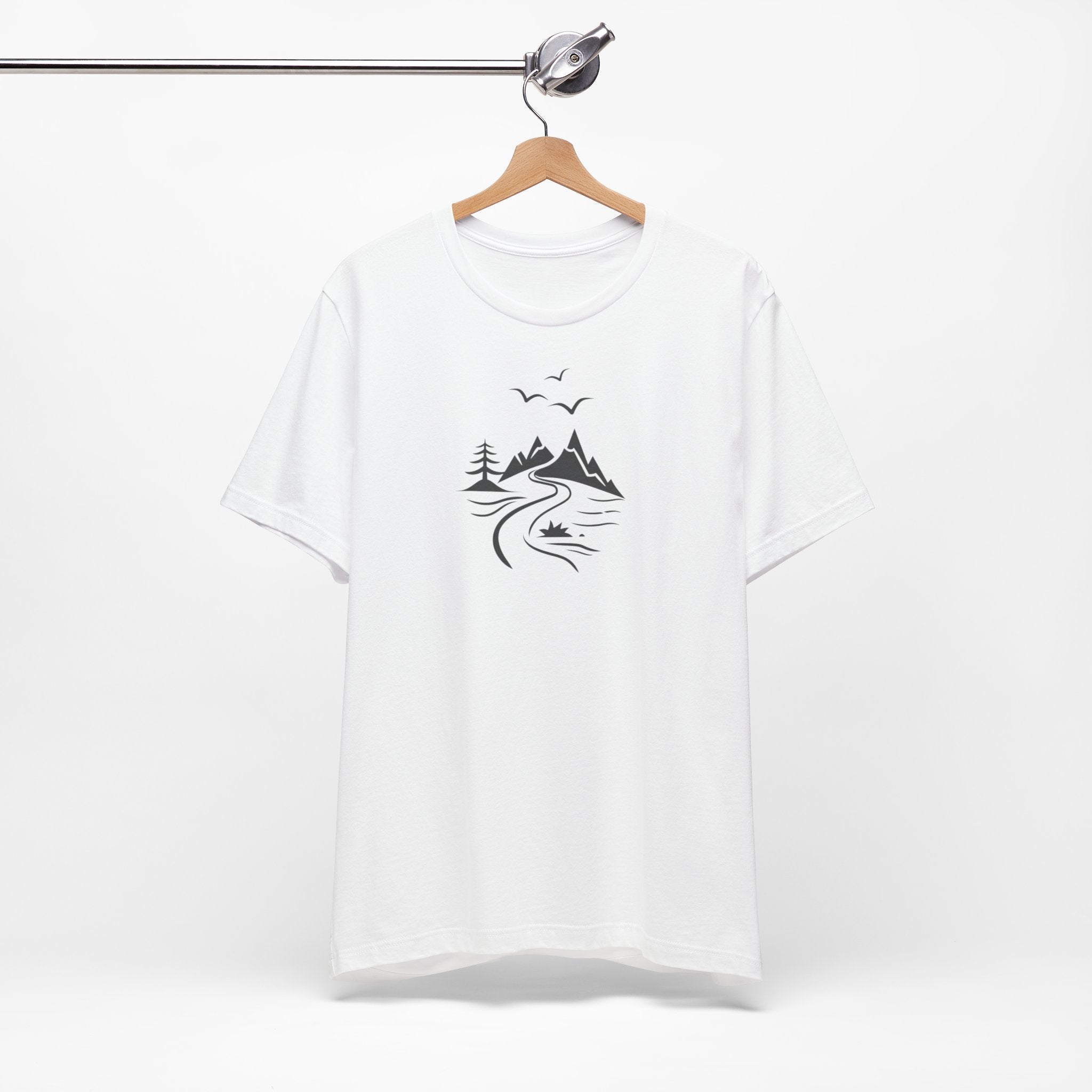 A white t-shirt featuring a minimalist black-and-white illustration of a mountain range, a river, and birds.
