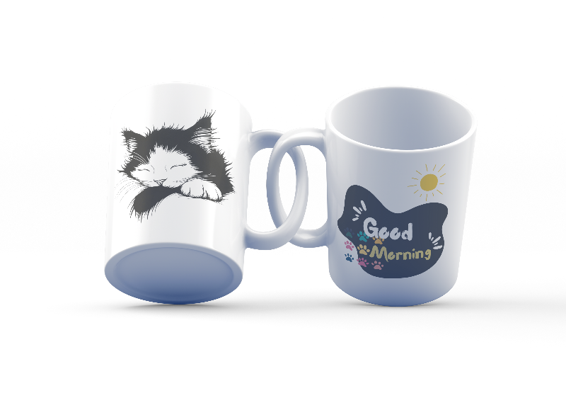 Two ceramic mugs, one with a 'Good Morning' design featuring paw prints and a sun, and the other with a black and white sleeping kitten design.