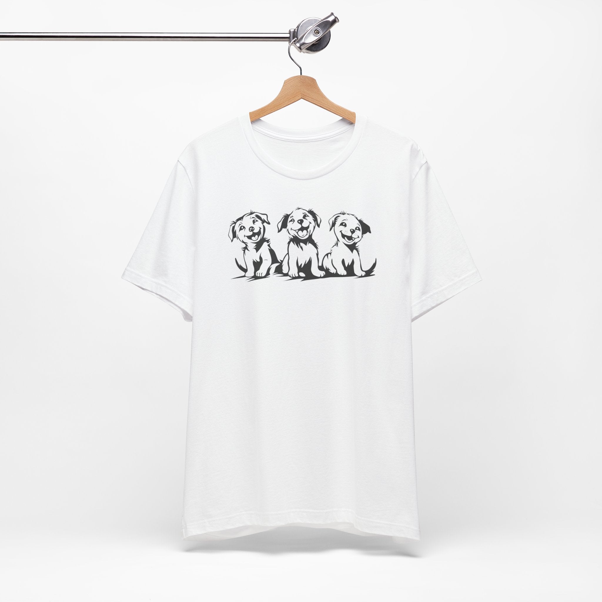 A white t-shirt featuring a graphic design of three smiling puppies sitting side by side.
