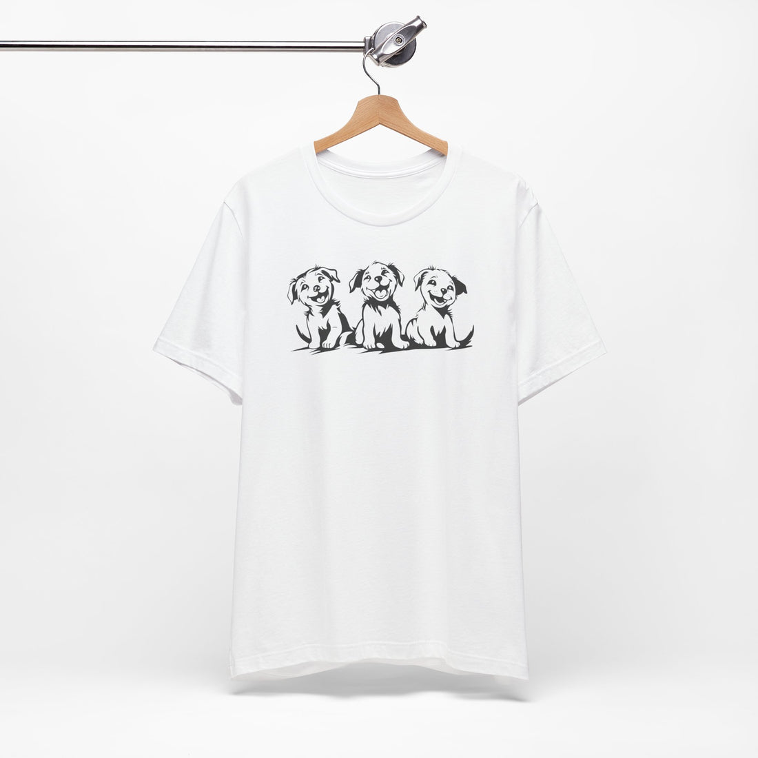 A white t-shirt featuring a graphic design of three smiling puppies sitting side by side.