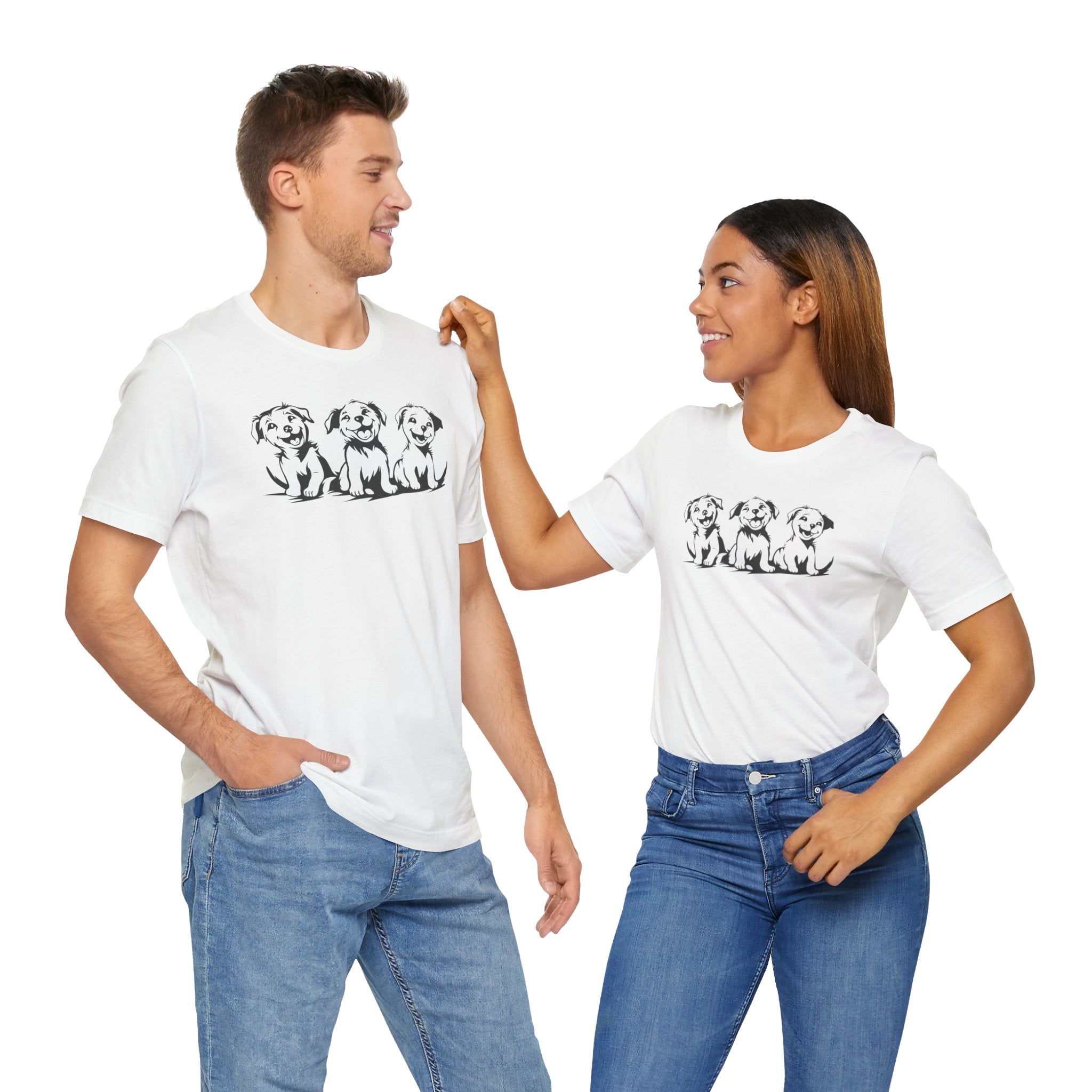 A white t-shirt featuring a graphic design of three smiling puppies sitting side by side.