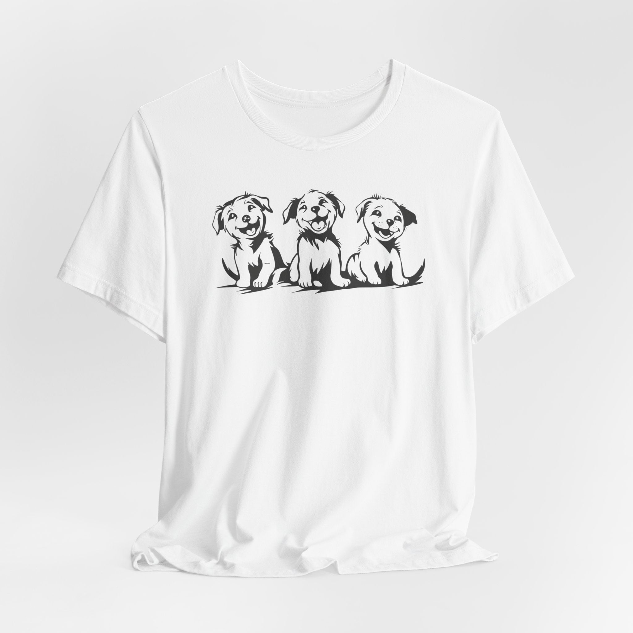 A white t-shirt featuring a graphic design of three smiling puppies sitting side by side.