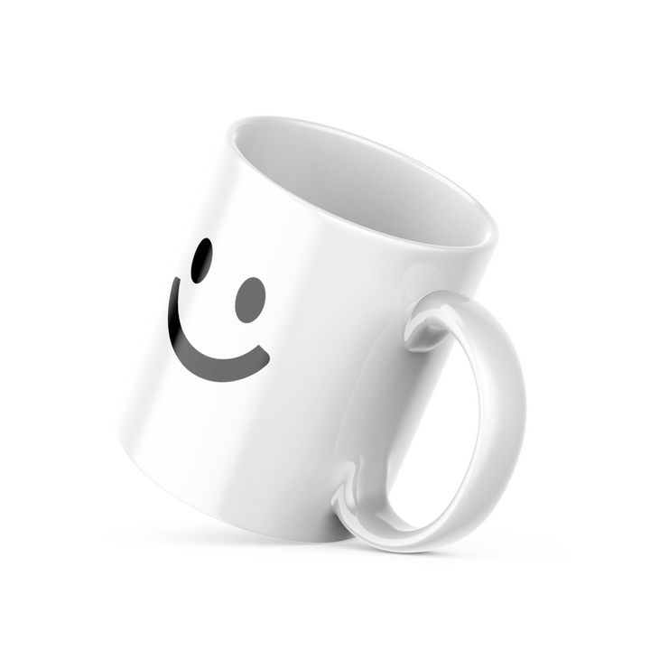 Two ceramic mugs, one with a minimalist smiley face design and the other with 'Good Morning' text and a sun graphic, both in black and yellow colors on a white background.