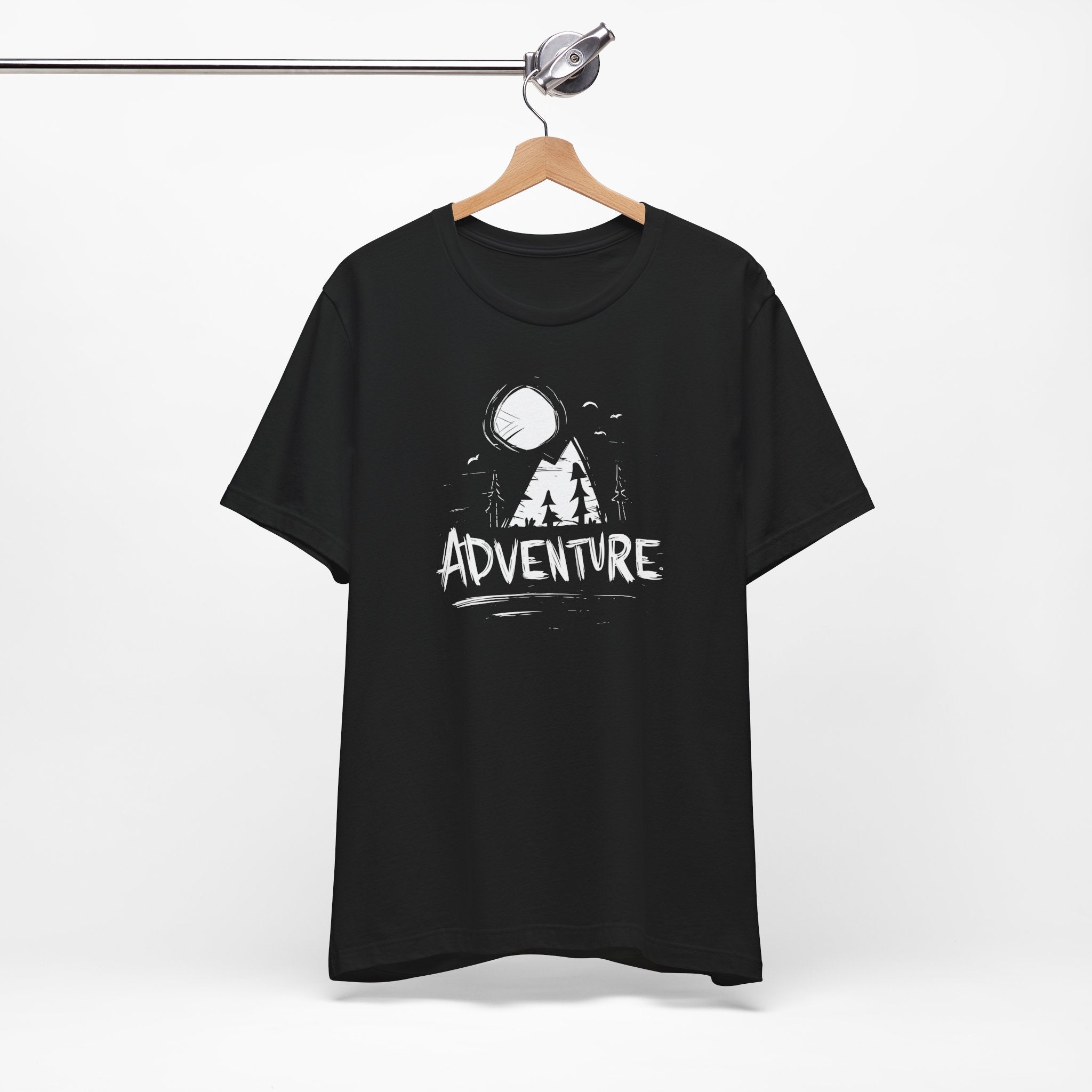 Black t-shirt with 'Adventure' graphic on a hanger against a white background