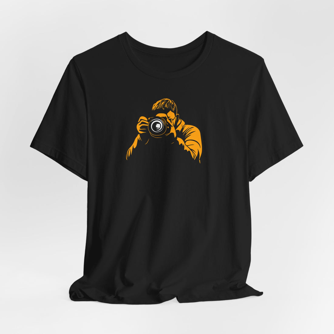 A black crew neck t-shirt with a bold yellow graphic of a photographer holding a camera.