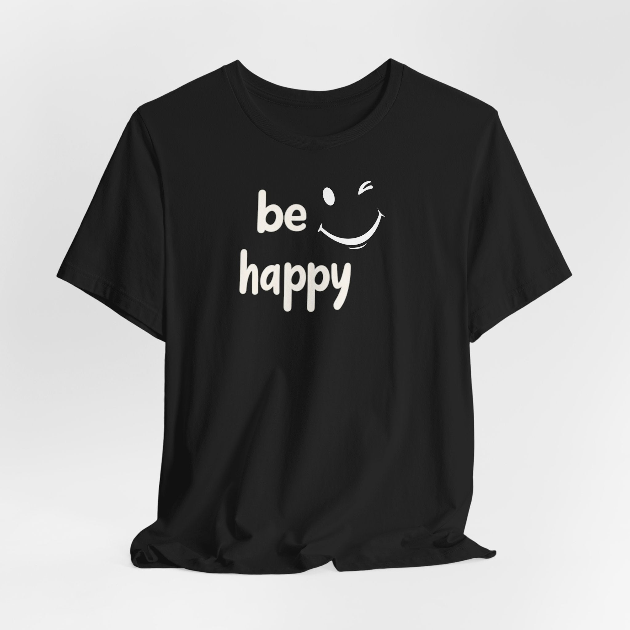 A black crew neck t-shirt with the text 'BE HAPPY' and a smiley face design on the front.