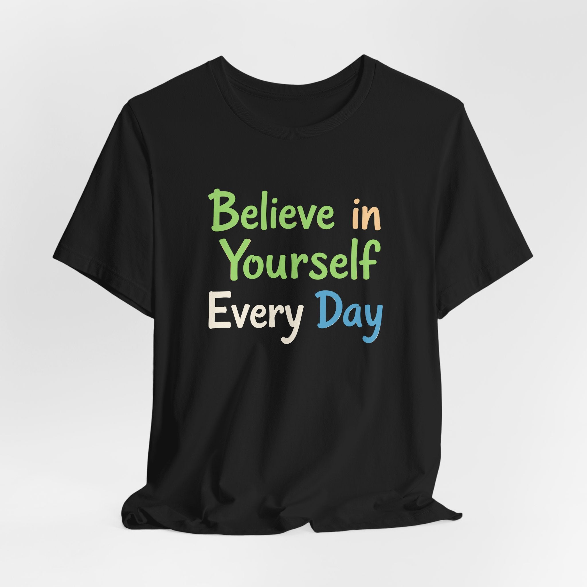 Black unisex t-shirt with the motivational phrase 'Believe in Yourself Every Day' printed in colorful typography.