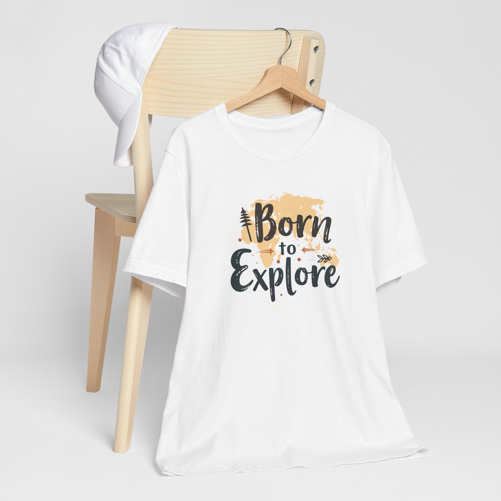 A white crew neck t-shirt with the text 'Born to Explore' printed on the front, accompanied by a globe and outdoor elements such as trees.