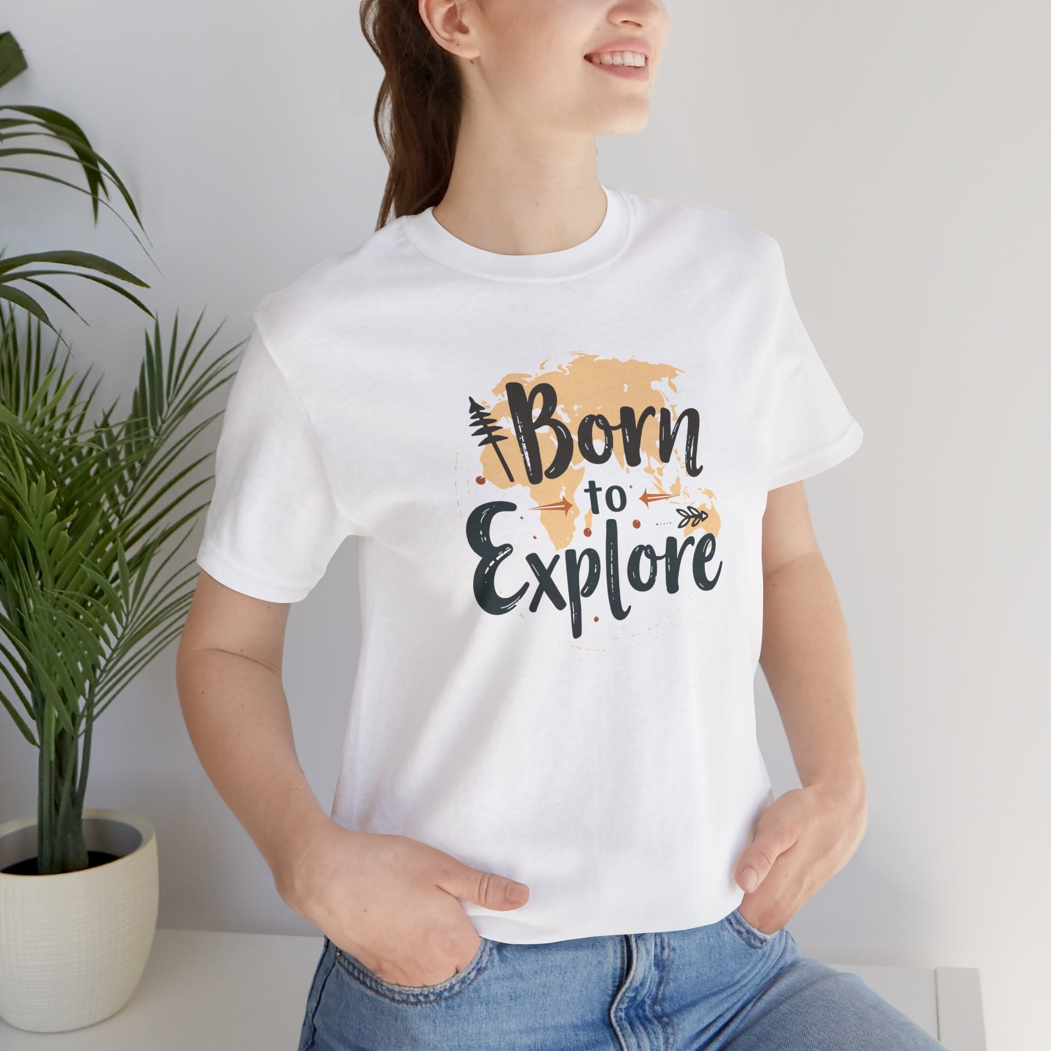 A white crew neck t-shirt with the text 'Born to Explore' printed on the front, accompanied by a globe and outdoor elements such as trees.
