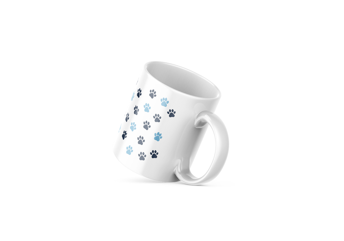 White ceramic mug with cute cat face design and paw prints