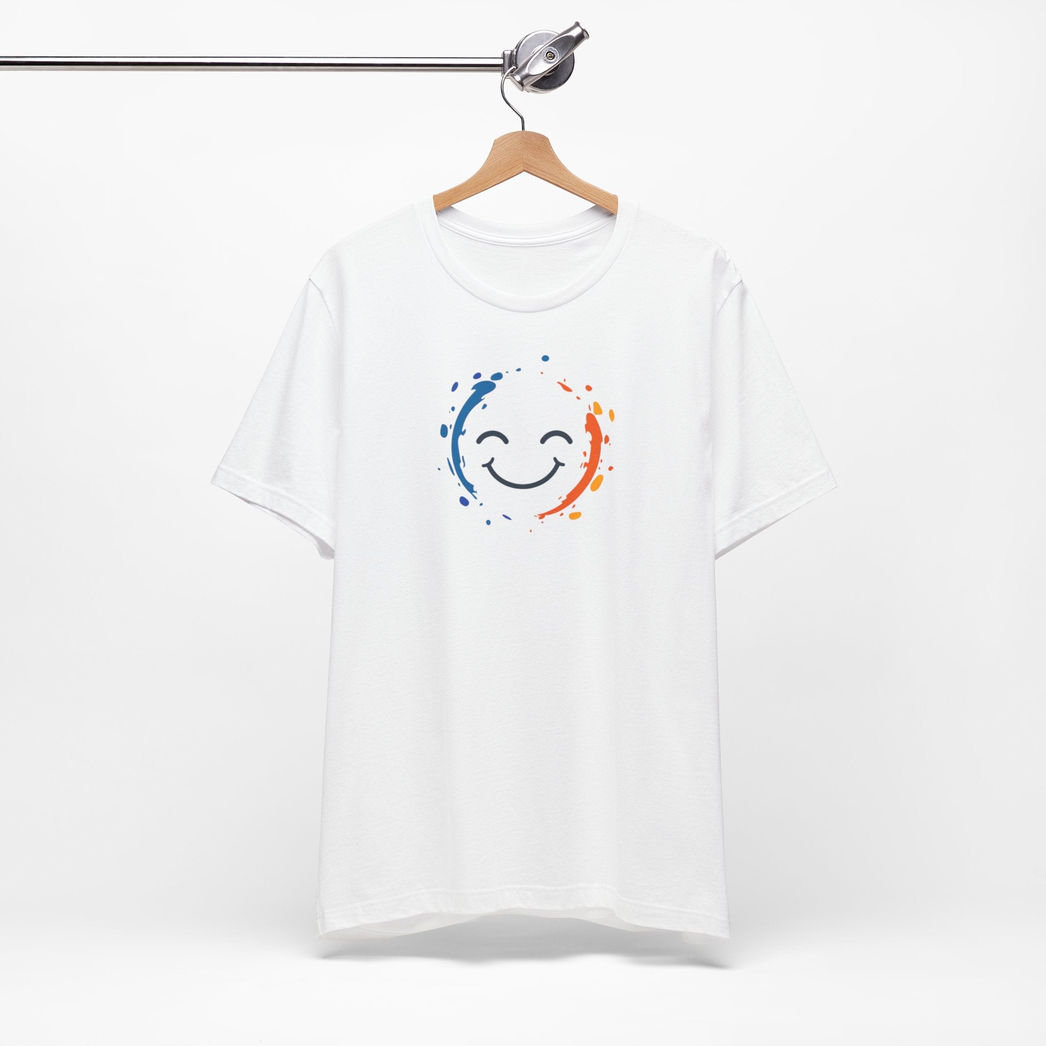 White cotton tee with a vibrant happy face design and color splashes in blue and orange.