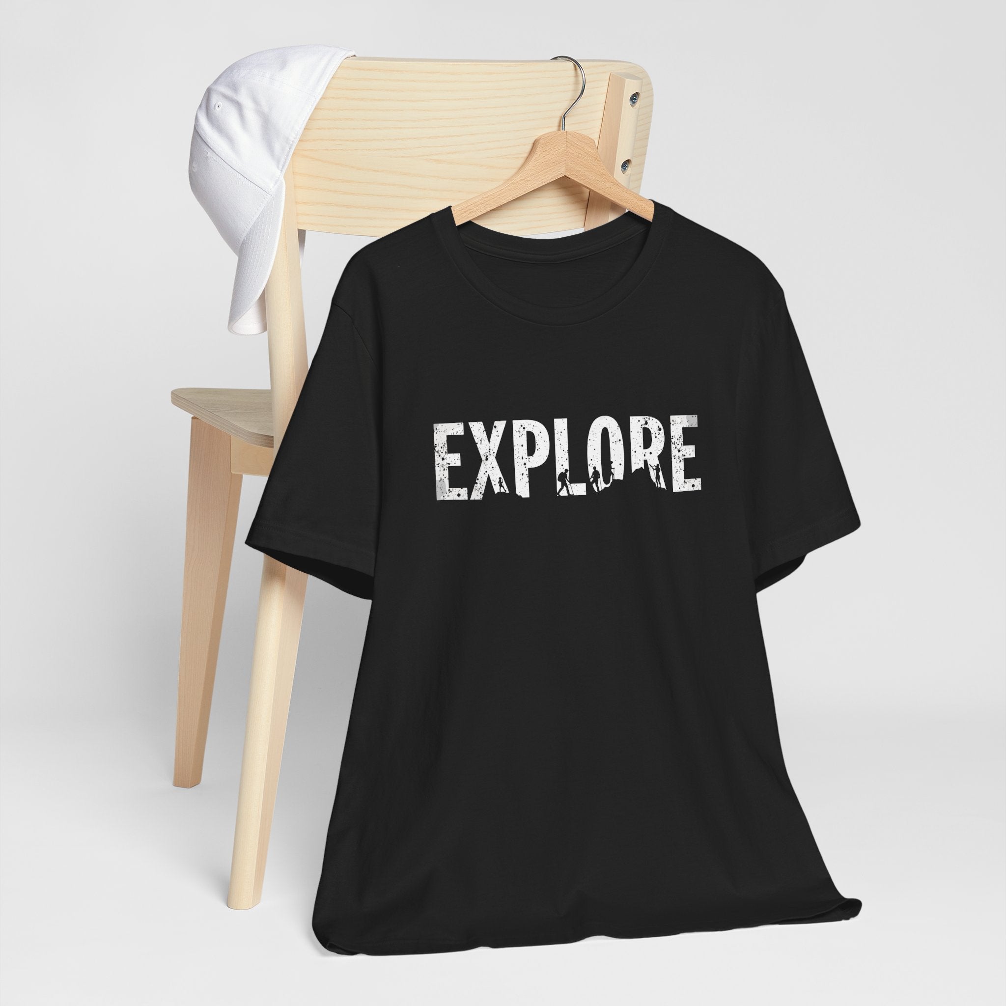Black cotton t-shirt with the word 'EXPLORE' printed in white, along with silhouettes of hikers and explorers.