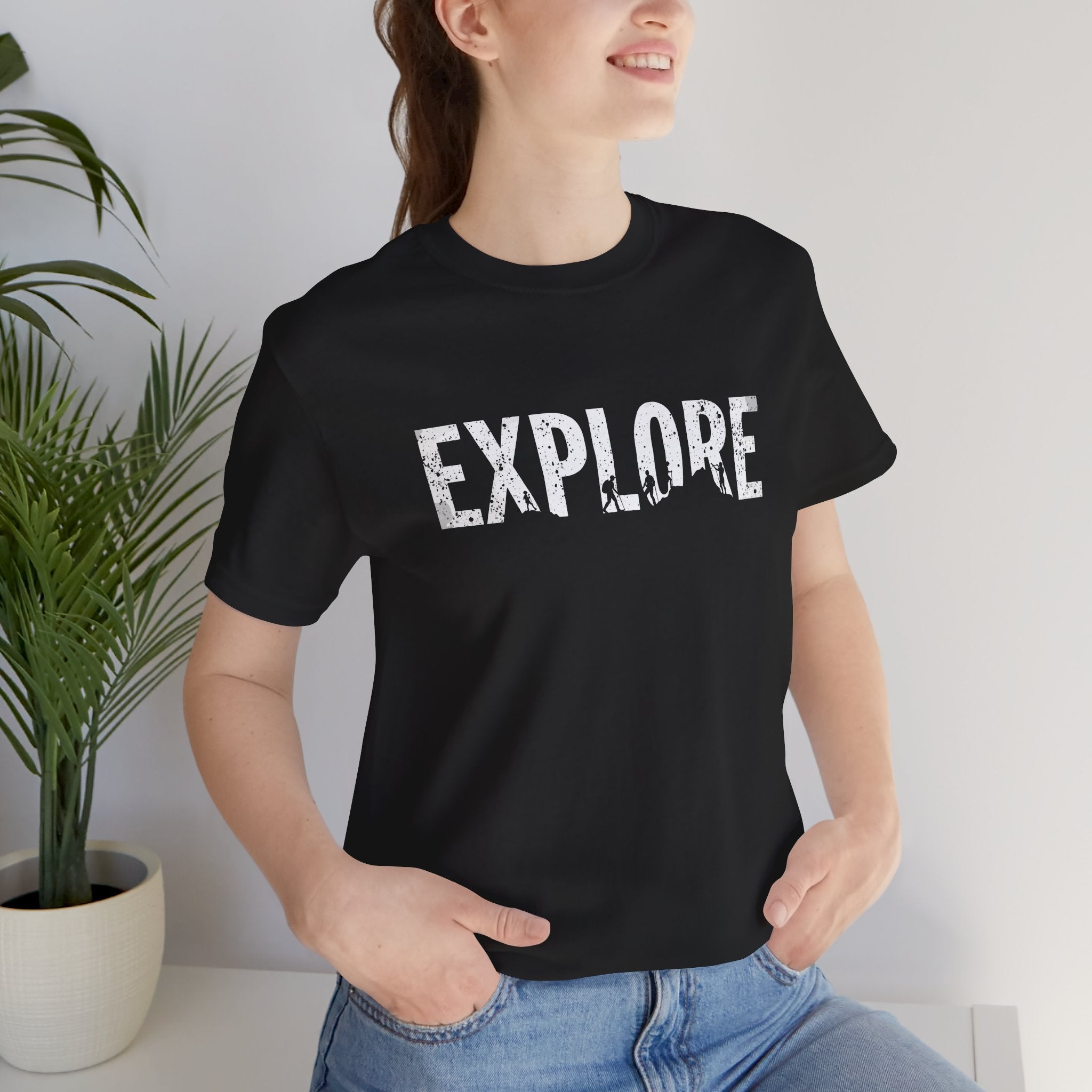 Black cotton t-shirt with the word 'EXPLORE' printed in white, along with silhouettes of hikers and explorers.
