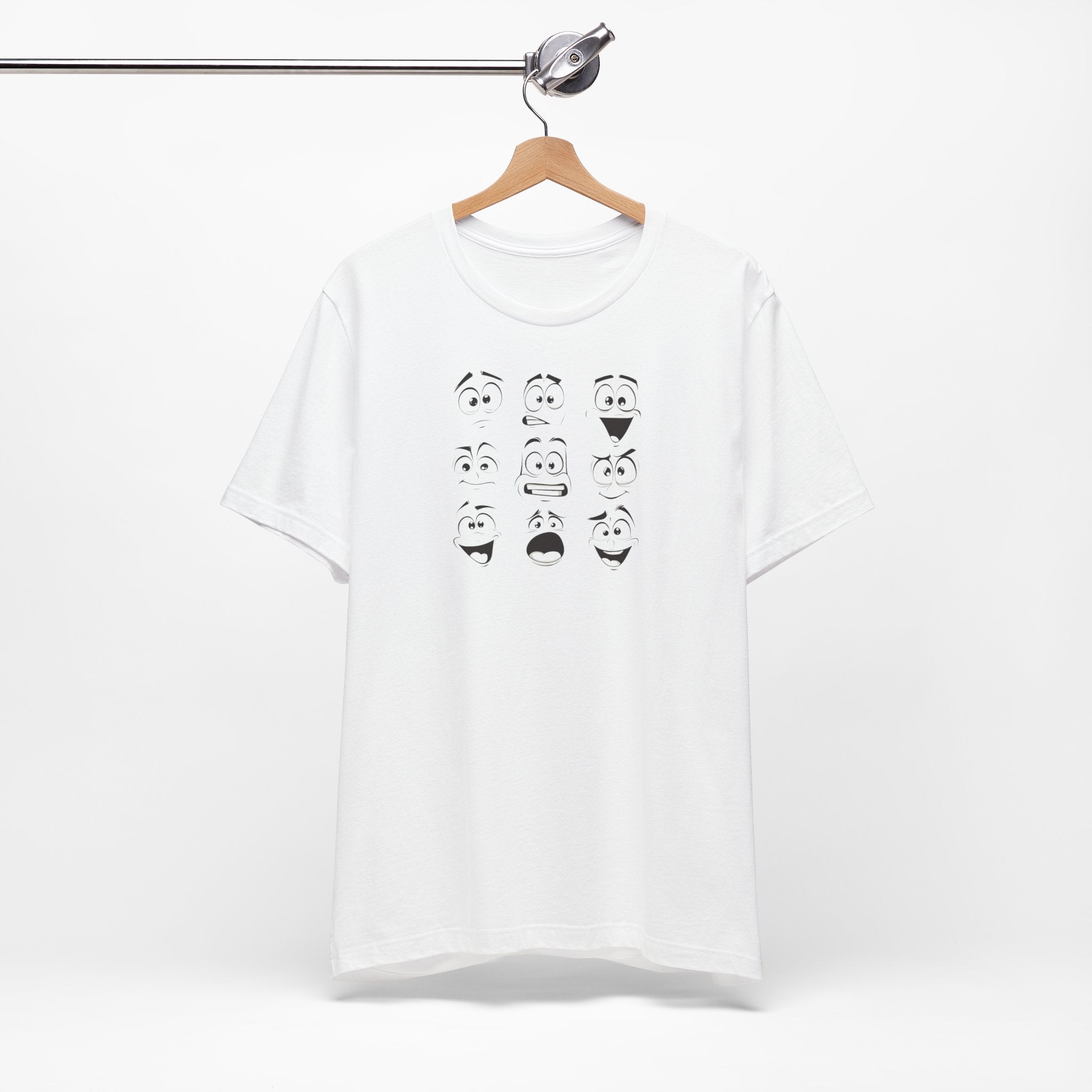 A white cotton unisex t-shirt featuring a design of various expressive cartoon faces.