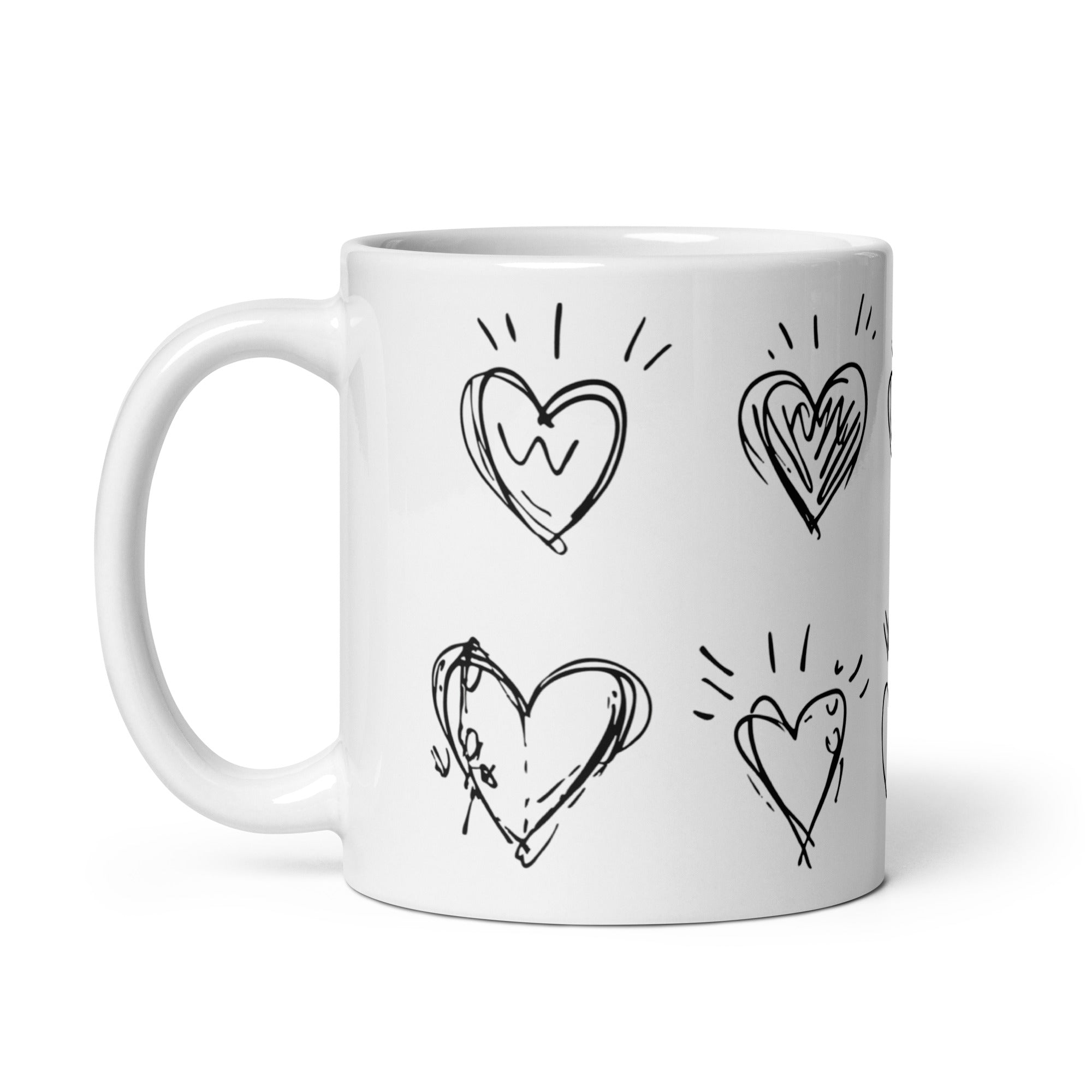 White mug with black heart designs on a white background