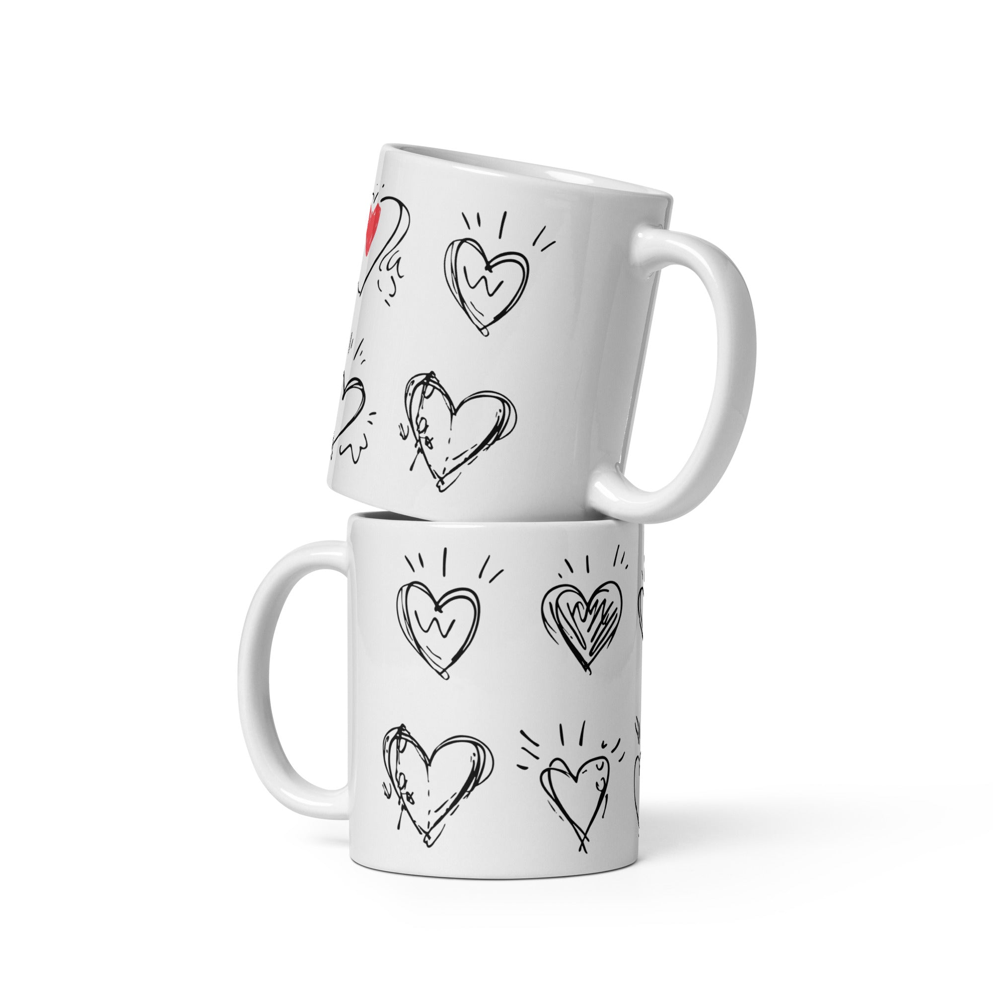 Two white mugs with heart designs stacked on a white background